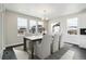 Elegant dining room with a modern chandelier, large windows providing natural light, and table with six chairs at 5566 Hickory Oaks Trl, Castle Rock, CO 80104