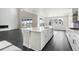 Open-concept kitchen with island, stainless steel appliances, and sliding glass doors to the outdoor patio at 5566 Hickory Oaks Trl, Castle Rock, CO 80104