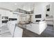 Bright open-concept living room featuring modern furniture, a sleek fireplace, and adjacent kitchen and dining area at 5566 Hickory Oaks Trl, Castle Rock, CO 80104