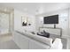 Modern living room featuring a plush sofa, stylish decor, and a large-screen television at 5566 Hickory Oaks Trl, Castle Rock, CO 80104