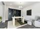 Stylish office featuring a custom built-in bookshelf, modern desk, chair and ottoman with a patterned rug at 5566 Hickory Oaks Trl, Castle Rock, CO 80104