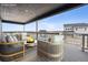 Relaxing outdoor patio with comfortable seating, a fire pit, and a view of surrounding houses at 5566 Hickory Oaks Trl, Castle Rock, CO 80104