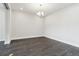 Bright room with neutral walls, gray floors, and a modern chandelier at 5566 Hickory Oaks Trl, Castle Rock, CO 80104