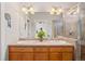 Elegant bathroom featuring double sinks, a large mirror, and a glass-enclosed shower for a spa-like experience at 84 Inca St, Denver, CO 80223