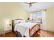 Cozy bedroom with a wood frame bed, a large window, and hardwood floors at 84 Inca St, Denver, CO 80223