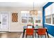 Charming dining area filled with natural light featuring modern decor, a stylish chandelier and a large window at 84 Inca St, Denver, CO 80223