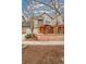 Charming gray two-story townhome featuring inviting front porch and well-manicured landscaping at 84 Inca St, Denver, CO 80223