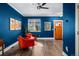 Elegant living room featuring vibrant walls, modern decor, and a front door view at 84 Inca St, Denver, CO 80223
