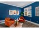 Inviting sitting area with accent chairs, artwork, and a bright window at 84 Inca St, Denver, CO 80223