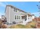 Back exterior highlighting a covered patio, verdant lawn, and easy yard access at 2538 Ambience Ln, Castle Rock, CO 80109