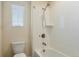 Cozy bathroom highlighting a tub with white tile surround and a showerhead, illuminated by a window at 2538 Ambience Ln, Castle Rock, CO 80109