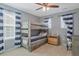 Charming bedroom showcasing a wooden bunk bed and stylish blue and white striped curtains at 2538 Ambience Ln, Castle Rock, CO 80109