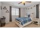 Charming bedroom with a window, ceiling fan, and a comfortable bed with blue plaid bedding at 2538 Ambience Ln, Castle Rock, CO 80109