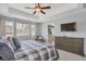 Spacious primary bedroom with tray ceilings, plush carpet, and access to an ensuite bathroom at 2538 Ambience Ln, Castle Rock, CO 80109