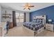 Bright bedroom boasts a ceiling fan and is furnished with a bed and matching wooden furniture at 2538 Ambience Ln, Castle Rock, CO 80109