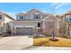 Charming two-story home featuring a brick-accented facade, manicured lawn, and an attached two-car garage at 2538 Ambience Ln, Castle Rock, CO 80109