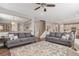 Spacious living room with an open floor plan, neutral decor, and access to the dining area and staircase at 2538 Ambience Ln, Castle Rock, CO 80109