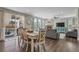 Open-concept living and dining area with a fireplace, ample natural light, and access to the backyard at 2538 Ambience Ln, Castle Rock, CO 80109