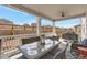 Inviting covered patio with comfortable seating and a glass-top dining table, perfect for entertaining at 2538 Ambience Ln, Castle Rock, CO 80109