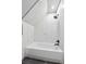 Modern bathroom featuring marble tiles, a sleek shower head, and a pristine white tub at 639 Quartz Way, Broomfield, CO 80020