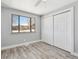 Cozy bedroom featuring wood floors, ample closet space, and a bright window at 639 Quartz Way, Broomfield, CO 80020