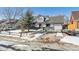 Charming home featuring a well-maintained front yard, attached garage, and inviting red door at 639 Quartz Way, Broomfield, CO 80020