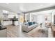 Bright living room featuring modern decor, wood floors, and plenty of natural light at 639 Quartz Way, Broomfield, CO 80020