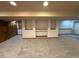 Spacious basement area with carpet and built-in shelving at 6044 S Yakima St, Aurora, CO 80015