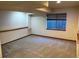 Finished basement with window and carpet at 6044 S Yakima St, Aurora, CO 80015