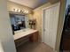 Bathroom vanity with a large mirror, vanity lighting, and view into the bedroom at 6044 S Yakima St, Aurora, CO 80015