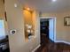 Entryway featuring hardwood floors, a recessed display nook, and views into adjacent rooms, enhancing the home's appeal at 6044 S Yakima St, Aurora, CO 80015