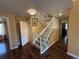 Welcoming foyer with hardwood floors, staircase with white railing, and neutral wall color that creates a warm and inviting ambiance at 6044 S Yakima St, Aurora, CO 80015