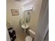 Half bathroom featuring pedestal sink, decorative mirror, and tile flooring, adding a touch of elegance and convenience at 6044 S Yakima St, Aurora, CO 80015