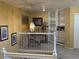 Bright upstairs hallway with white railing, carpeted floor, and natural light at 6044 S Yakima St, Aurora, CO 80015