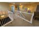 Bright upstairs hallway with white railing, and carpeted floor at 6044 S Yakima St, Aurora, CO 80015