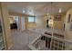 Bright upstairs hallway with white railing, carpeted floor, and natural light at 6044 S Yakima St, Aurora, CO 80015