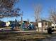 Community playground with blue slides and climbing structure on a sunny day at 6044 S Yakima St, Aurora, CO 80015