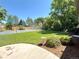 Lush backyard with a fenced tennis court, mature trees, and well-maintained lawn, perfect for outdoor activities at 9451 E Evans Pl, Denver, CO 80231