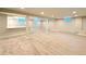 Spacious basement with neutral carpet, recessed lighting, and a bar area, perfect for entertaining at 9451 E Evans Pl, Denver, CO 80231