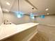 Basement bar featuring stone countertop, sink and modern pendant lighting at 9451 E Evans Pl, Denver, CO 80231