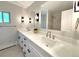 Elegant bathroom featuring a double vanity, quartz counters and modern lighting at 9451 E Evans Pl, Denver, CO 80231