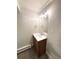 Bathroom vanity featuring a wood cabinet, neutral walls, and updated fixtures at 9451 E Evans Pl, Denver, CO 80231