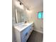 Bright bathroom featuring a double vanity with white cabinets and modern black hardware at 9451 E Evans Pl, Denver, CO 80231