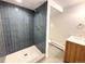 Modern bathroom with honeycomb tile shower and updated vanity with sleek fixtures at 9451 E Evans Pl, Denver, CO 80231