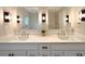 Modern bathroom vanity featuring dual sinks, quartz countertops, and stylish fixtures at 9451 E Evans Pl, Denver, CO 80231