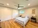 Comfortable bedroom with hardwood floors, closet space, and a ceiling fan for added comfort at 9451 E Evans Pl, Denver, CO 80231