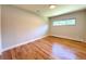 Sunlit bedroom featuring gleaming hardwood floors and a bright, airy atmosphere at 9451 E Evans Pl, Denver, CO 80231