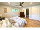 Bright bedroom with hardwood floors, neutral walls, and ample natural light from the windows at 9451 E Evans Pl, Denver, CO 80231