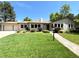 Charming ranch style home with beautiful lawn, landscaped yard, and attached two car garage at 9451 E Evans Pl, Denver, CO 80231