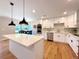Bright kitchen featuring a quartz island, stainless appliances, modern lighting, and eat in dining area at 9451 E Evans Pl, Denver, CO 80231